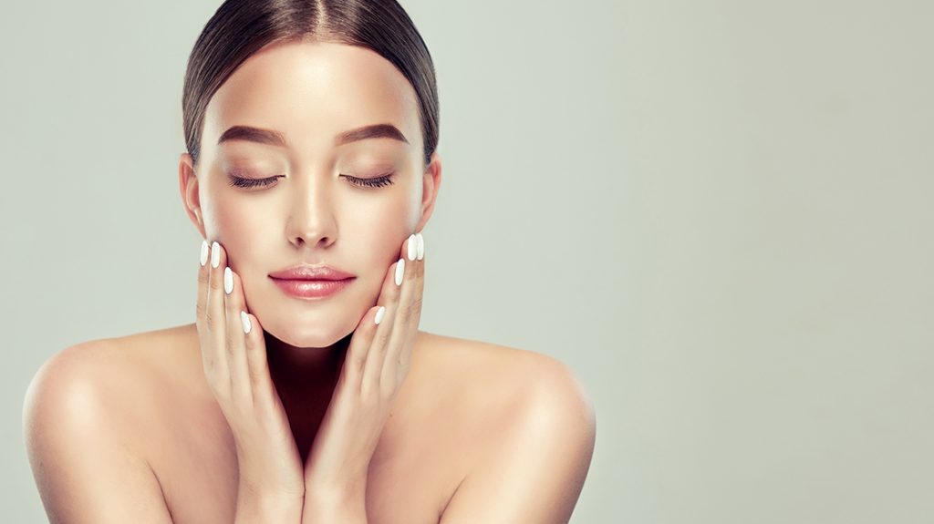 Woman massaging her face